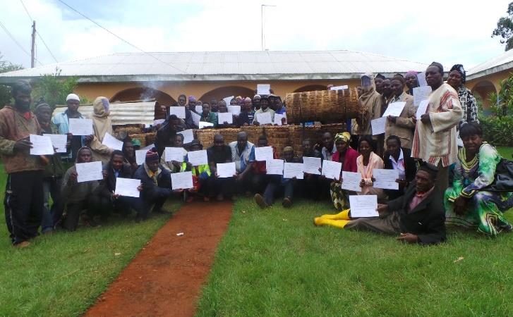 Bee farmers receiving certificates after a training workshop