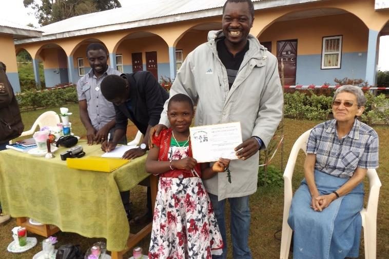 A young participant receiving a training certificate