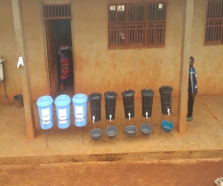 Waste-separation bins and hand-washing stations in a school